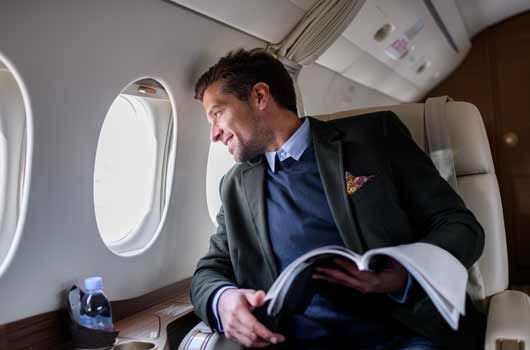 man on jet looking out window